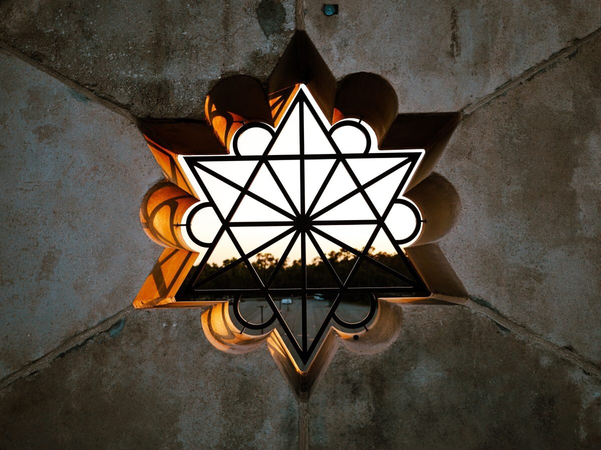 A star-shaped window in a stone wall