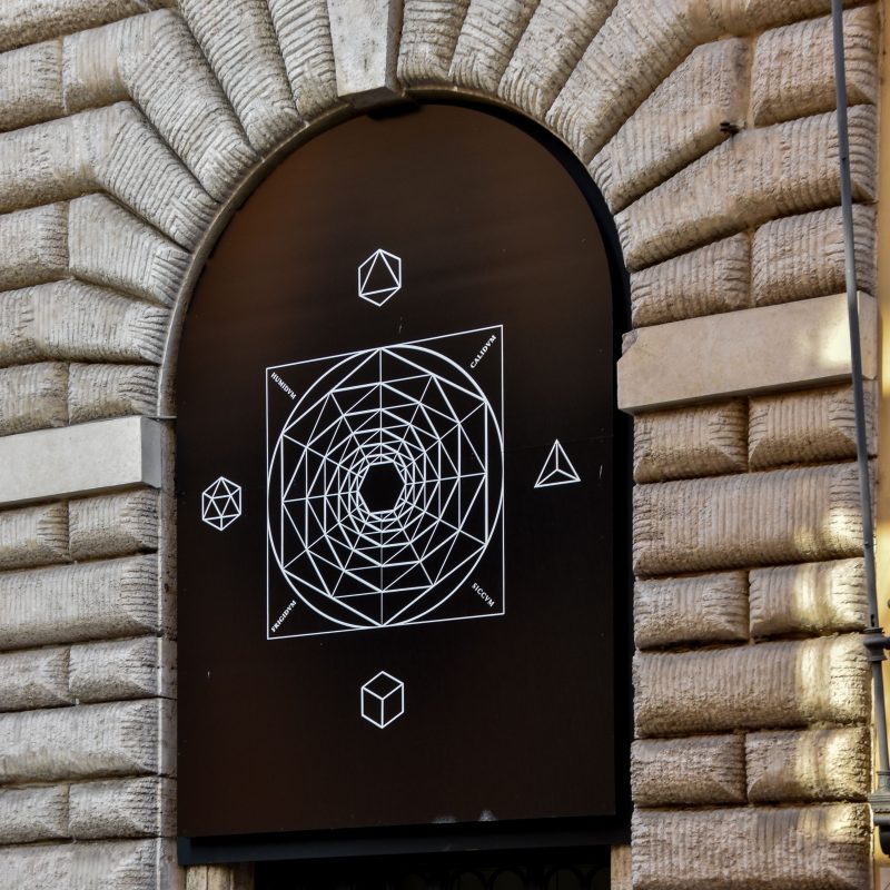 Geometric mural inside a stone arch