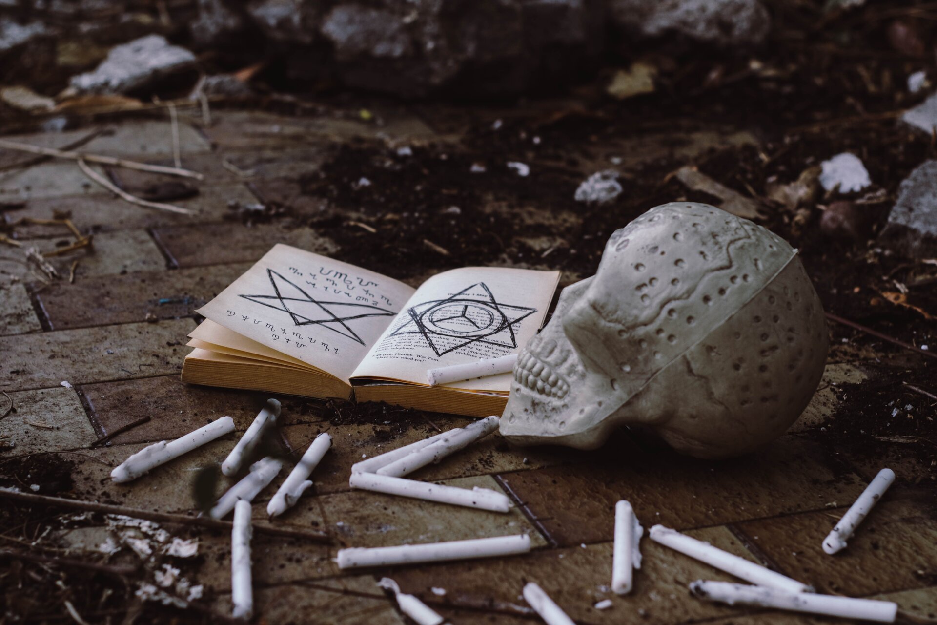 An open book beside a carved skull
